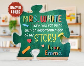 May include: A green puzzle piece-shaped sign with the text "MRS. WHITE" in colorful letters. The sign reads "Thank you for being such an important piece of my STORY. Love, Emma." A red circle indicates the item is ready in 6 hours.