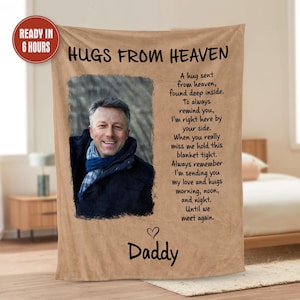 May include: A brown and beige fleece blanket with a photo of a man and a message that reads "Hugs from Heaven." The message includes a poem about sending love and hugs from heaven. The blanket is personalized with the word "Daddy" at the bottom.