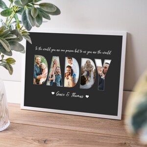 May include: White framed print with the word "DADDY" in large letters, each filled with a different family photo. The text "To the world you are one person but to us you are the world" is above the word "DADDY". The names "Grace & Thomas" are below.