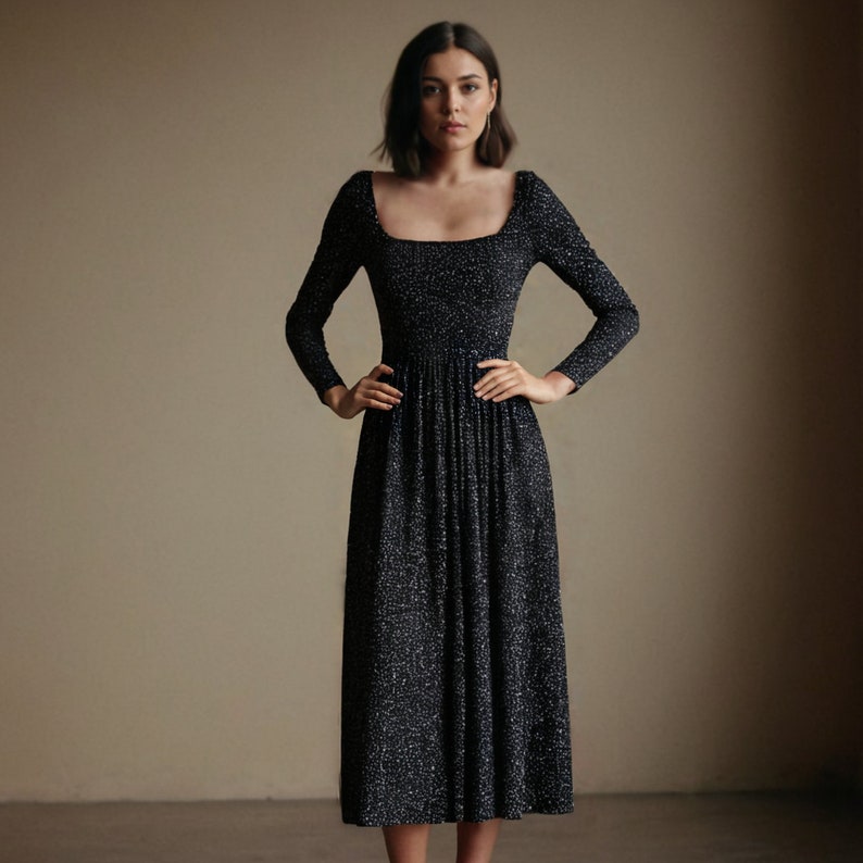 May include: A black midi dress with a white polka dot pattern. The dress has a square neckline and a fitted bodice. The skirt is full and falls to the knees.