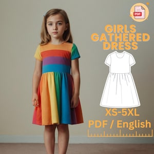 May include: A PDF sewing pattern for a gathered dress for girls. The pattern includes sizes XS-5XL and is written in English. The image shows a young girl wearing a rainbow striped dress.