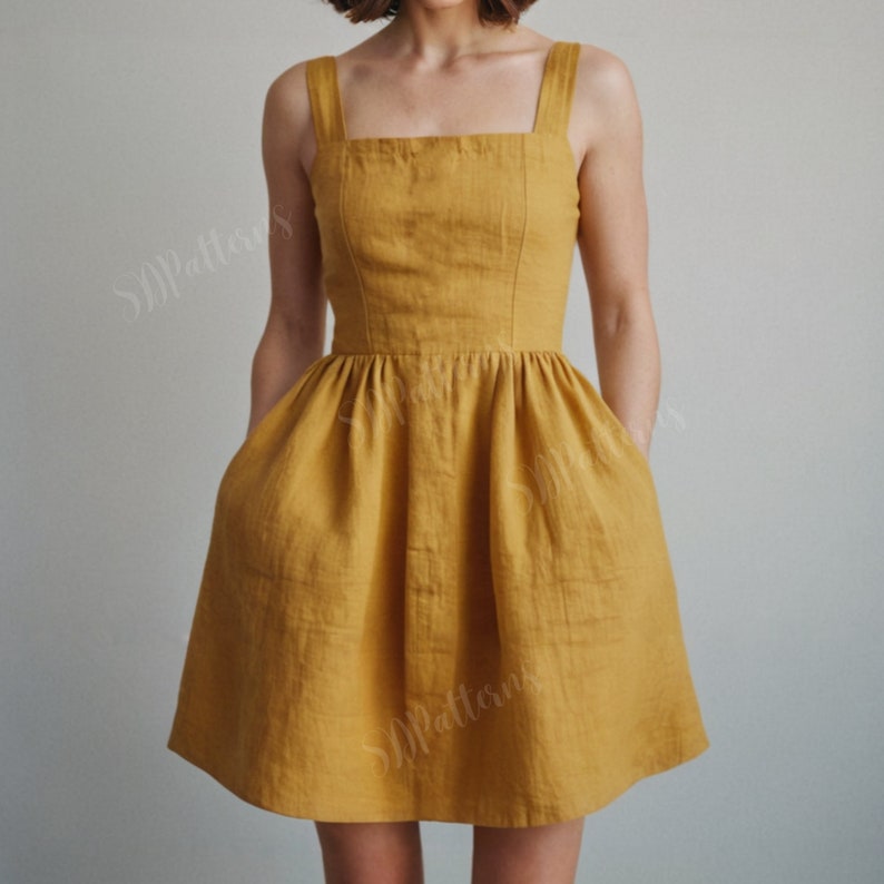 May include: A yellow linen dress with a square neckline, thin straps, and pockets. The dress has a fitted bodice and a flowy skirt.