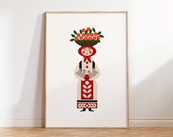 May include: A framed print featuring a stylized illustration of a person in traditional attire. The figure carries a basket of oranges on their head. The artwork has a folk art style with a white background and a wooden frame.