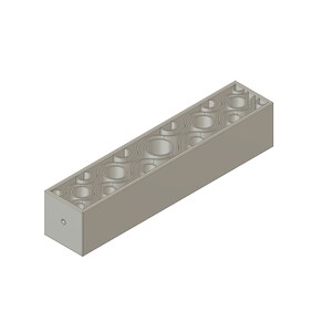May include: A gray rectangular block with a decorative pattern of circles and wavy lines cut out of the top. The block has a small hole on one side.