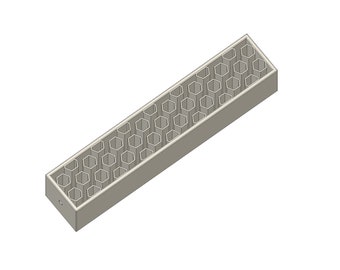 May include: A gray rectangular box with a honeycomb pattern of holes on the top. The box is made of plastic or metal and has a smooth surface.
