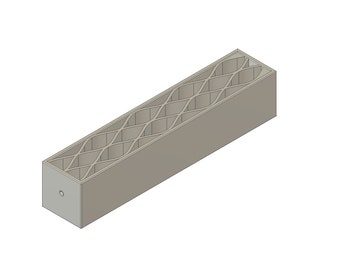 May include: A gray rectangular box with a geometric pattern of holes cut into the sides. The box is made of a solid material and has a smooth finish.