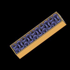 May include: A rectangular box with a gold-colored exterior and a patterned top. The top features a repeating design of blue and gold curved shapes. The box is set against a black background.