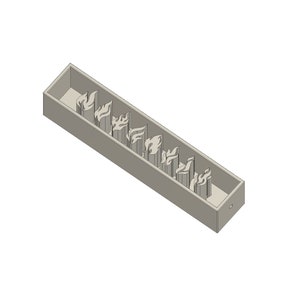 May include: A gray rectangular box with a row of flame-shaped cutouts. The box is made of a smooth, matte material.