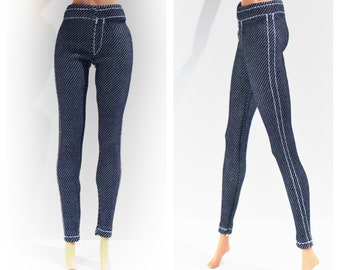 May include: A pair of dark blue denim jeans with white stitching. The jeans are shown on a doll figure.