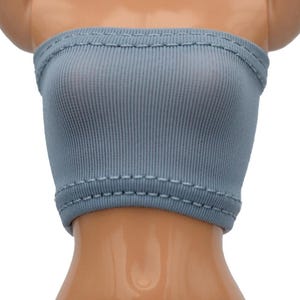 May include: A light blue ribbed tube top with a stitched hem.