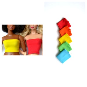 May include: A set of six colorful tube tops for dolls. The tops are in a rainbow color scheme, starting with red and ending with blue. The tops are made of a soft, stretchy fabric and are perfect for doll clothes.