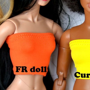 May include: Five different sized doll torsos wearing strapless tops in various colors: turquoise, green, orange, yellow, and red. The text "Regular size", "Tall Barb", "FR doll", "Curvy size", and "Model Muse" is written below each torso.