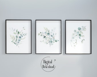 Peut inclure: Trois impressions aquarelle encadrées de branches d'eucalyptus avec des feuilles vertes et bleues sur un fond blanc. Les cadres sont noirs.