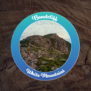 May include: A blue and green circle with the text "Bondcliff White Mountains" in white. Inside the circle is a photo of a rocky mountain path with a map overlay.