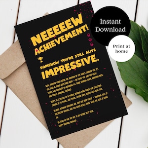 May include: A black greeting card with yellow text that reads "NEEEEEW ACHIEVEMENT! SOMEHOW YOU'RE STILL ALIVE IMPRESSIVE." The card has a trophy graphic and is on a brown envelope. A black circle with "Instant Download" is on the right.