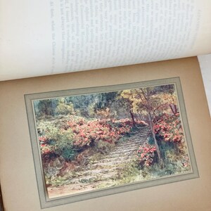 May include: A vintage print of a stone stairway winding through a garden, lined with vibrant pink azaleas. The artwork, titled "Azaleas by an Old Stairway, Kyoto," is framed within a larger book page.