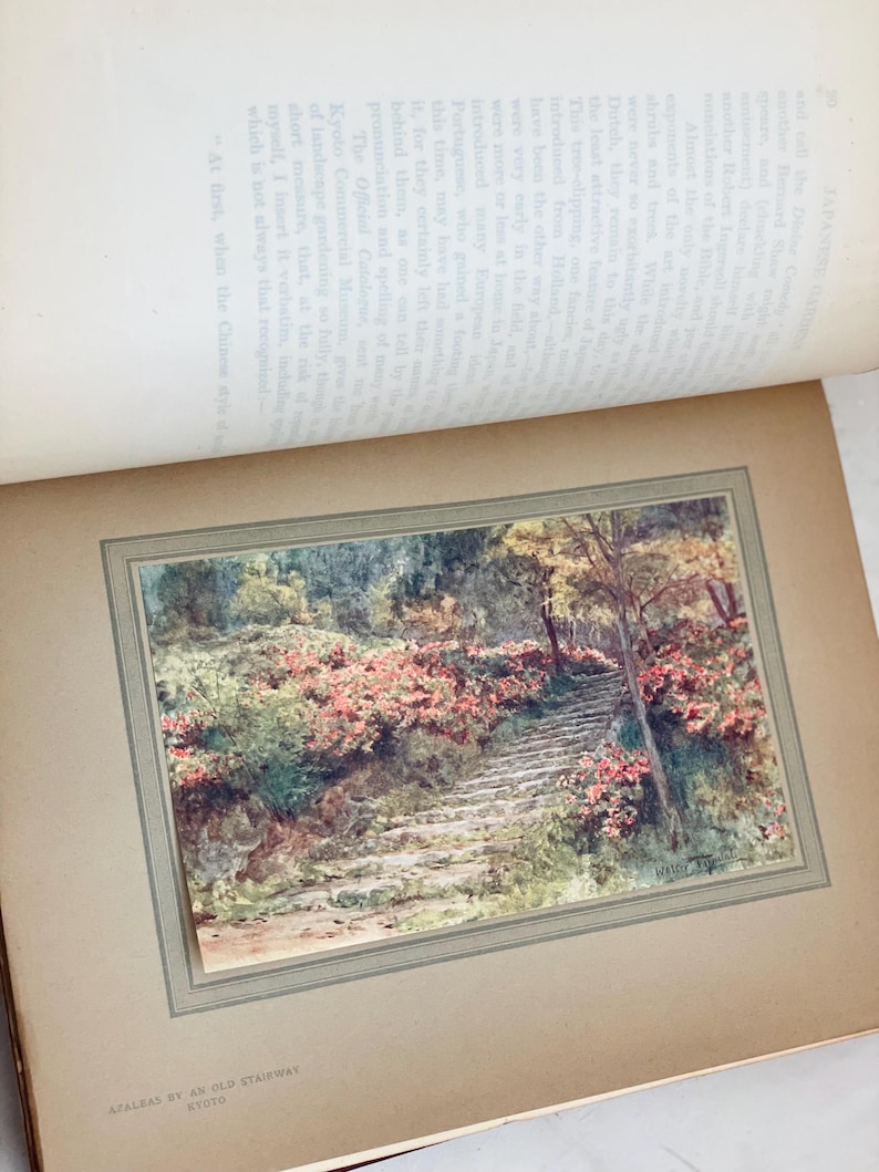 May include: A vintage print of a stone stairway winding through a garden, lined with vibrant pink azaleas. The artwork, titled "Azaleas by an Old Stairway, Kyoto," is framed within a larger book page.