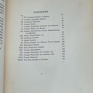 May include: An open book page with the title "CONTENTS" at the top. The page lists chapter titles and page numbers, including topics like Japanese gardens, gardening history, and flower arrangement. The text is in black font.