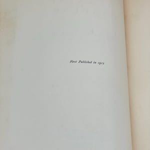 May include: Open book pages with the text "First Published in 1912" printed in black. The pages are off-white with a slight texture. The right page is slightly yellowed.