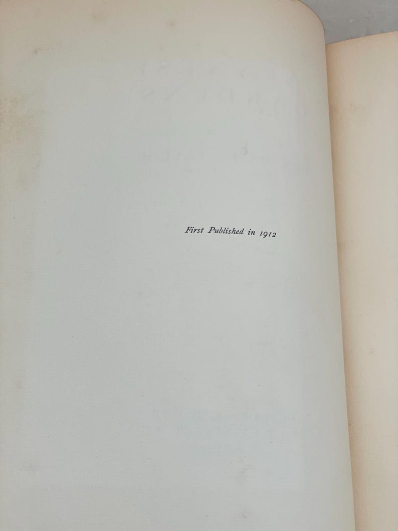 May include: Open book pages with the text "First Published in 1912" printed in black. The pages are off-white with a slight texture. The right page is slightly yellowed.