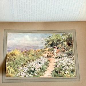 May include: A vintage watercolor print titled "Work at Kyoto" depicts a garden path lined with white flowers, leading to a figure with a parasol. The background shows a pagoda and lush greenery, with a soft, muted color palette.