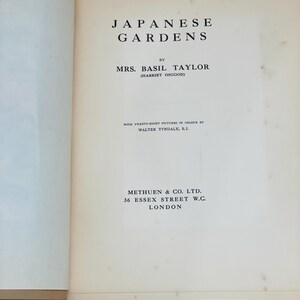 May include: Open book titled "Japanese Gardens" by Mrs. Basil Taylor. The cover features black text on an off-white page. The book includes information about the author and publisher, Methuen & Co. Ltd., located in London.