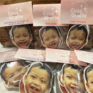 May include: Six car air fresheners with different scents and designs. Each air freshener features a child's face and the text "Evee Crafts" with the scent name below. The scents are Lavender Blooms & Sandalwood, Volcano, Pink Lychee, Volcano, Lavender Blooms & Sandalwood, and Pink Lychee.