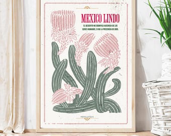 May include: A vintage-style poster with a green cactus and pink flowers. The text on the poster reads "Mexico Lindo" and "El desierto no significa ausencia de los seres humanos, si no la presencia de Dios." The poster also includes the text "Mexillicious".