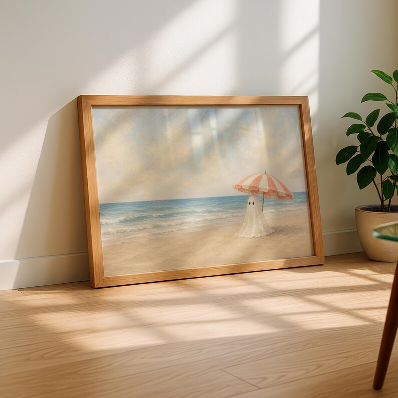 Beach house art print featuring a charming ghost beneath a vintage striped umbrella against calm blue water and a warm cream sky with painterly details.