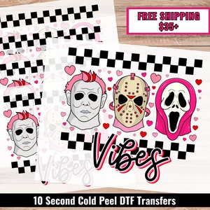 May include: Ten 10-second cold peel DTF transfers featuring pink hearts, a black and white checkered pattern, and three horror movie character masks: Michael Myers, Jason Voorhees, and Ghostface. The text "Vibes" is written in pink and black letters.