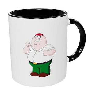 May include: White ceramic mug with a black rim and handle. The mug features a cartoon image of Peter Griffin from the animated television show Family Guy. Peter is wearing a white shirt, green pants, and a red hat. He is smiling and has his arms raised.