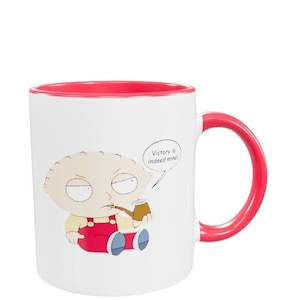 May include: White ceramic mug with a red rim and handle. The mug features a cartoon image of a character with the text "Victory is indeed mine!" in a speech bubble.