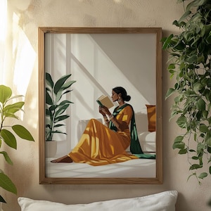 May include: A framed illustration of a woman in a yellow and green sari sitting on a bed and reading a book. The woman is wearing jewelry and has her hair pulled back. The background is a white wall with a window.
