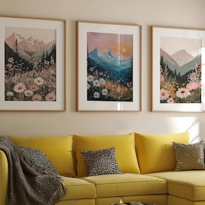 May include: A living room scene featuring a yellow sectional sofa with decorative pillows and a patterned throw blanket. Three framed landscape art prints hang above the sofa. A round coffee table sits in front of the sofa.