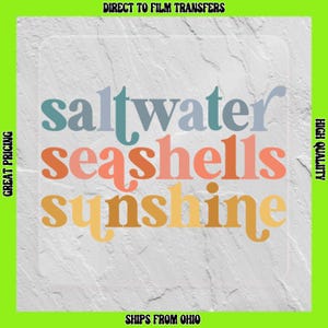 May include: A white textured background with the words "saltwater seashells sunshine" in a colorful font. The words are in a stacked arrangement, with "saltwater" in blue, "seashells" in pink, and "sunshine" in yellow.