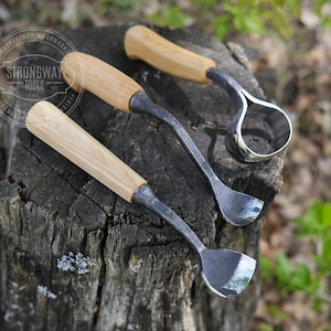 May include: Three wood carving tools with wooden handles. The tools are made of metal and have different shapes for carving wood. The tools are on a tree stump.