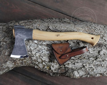 May include: A small, hand-forged axe with a wooden handle and a leather sheath. The axe is made by Strongway Tools.