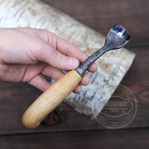 May include: A wooden handled carving tool with a curved metal blade. The tool is made by Strongway Tools, Handmade Forge of Ukraine.