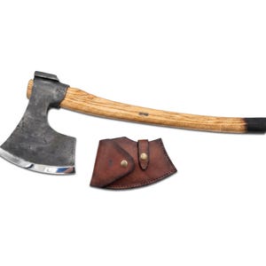 May include: Axe with a wooden handle and a dark metal head, alongside a brown leather sheath. The handle is light-colored wood with a black finish at the end. The axe head has a silver edge.