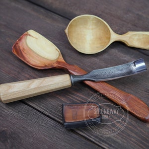 May include: Three wooden spoons and a wood carving tool with a metal blade. The spoons are made of different types of wood and have a natural finish. The carving tool has a wooden handle and a metal blade. The tools are arranged on a wooden surface. Strongway Tools Handmade, forged in Ukraine.