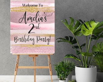 May include: Welcome to Amelia's 2nd Birthday Party! Pink and gold watercolor birthday party sign with glitter accents.