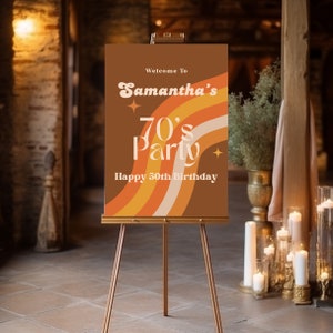 May include: A brown welcome sign with a retro 70s design featuring orange and yellow stripes. The sign reads "Welcome to Samantha's 70's Party Happy 50th Birthday".