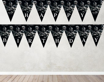 May include: A black and white birthday banner with a camouflage pattern and the words "Happy Birthday" printed on it.