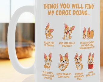 May include: A white ceramic mug featuring the text "THINGS YOU WILL FIND MY CORGI DOING..." above six cartoon illustrations of a Corgi dog in various poses, each with a caption describing the activity, including playing fetch and dancing.