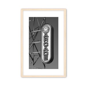 Black and white photograph of a vintage arcade sign on the Wildwood, NJ Boardwalk with gritty industrial details.