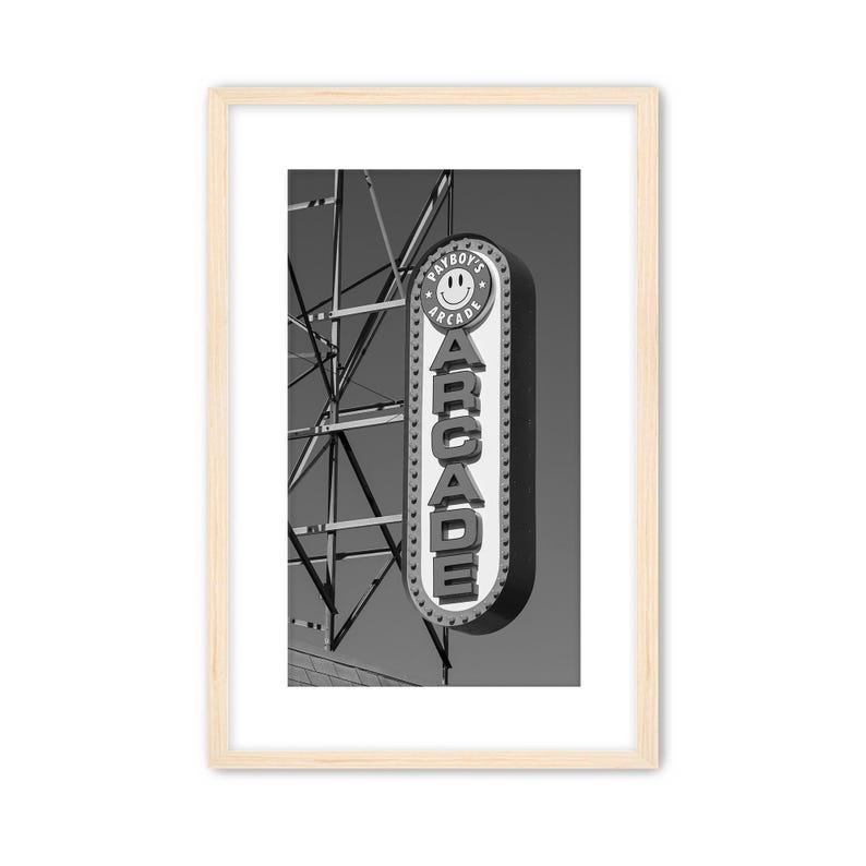 Black and white photograph of a vintage arcade sign on the Wildwood, NJ Boardwalk with gritty industrial details.