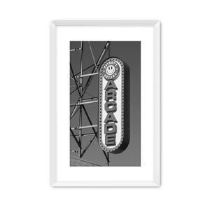 Black and white photograph of a vintage arcade sign on the Wildwood, NJ Boardwalk with gritty industrial details.