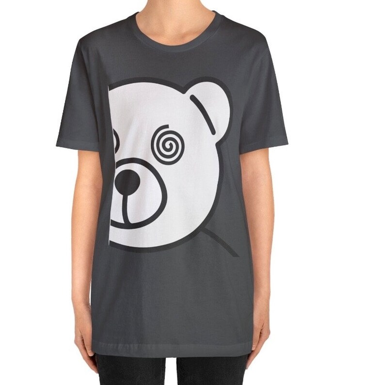 May include: A dark gray t-shirt with a white bear face graphic. The bear has a spiral design in one eye.
