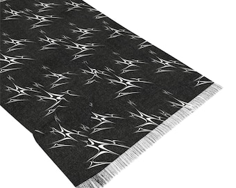 May include: Black scarf with a white abstract pattern and fringed edges.