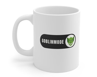 May include: White ceramic coffee mug with a black and white graphic of a goblin face and the text "GOBLINMODE".